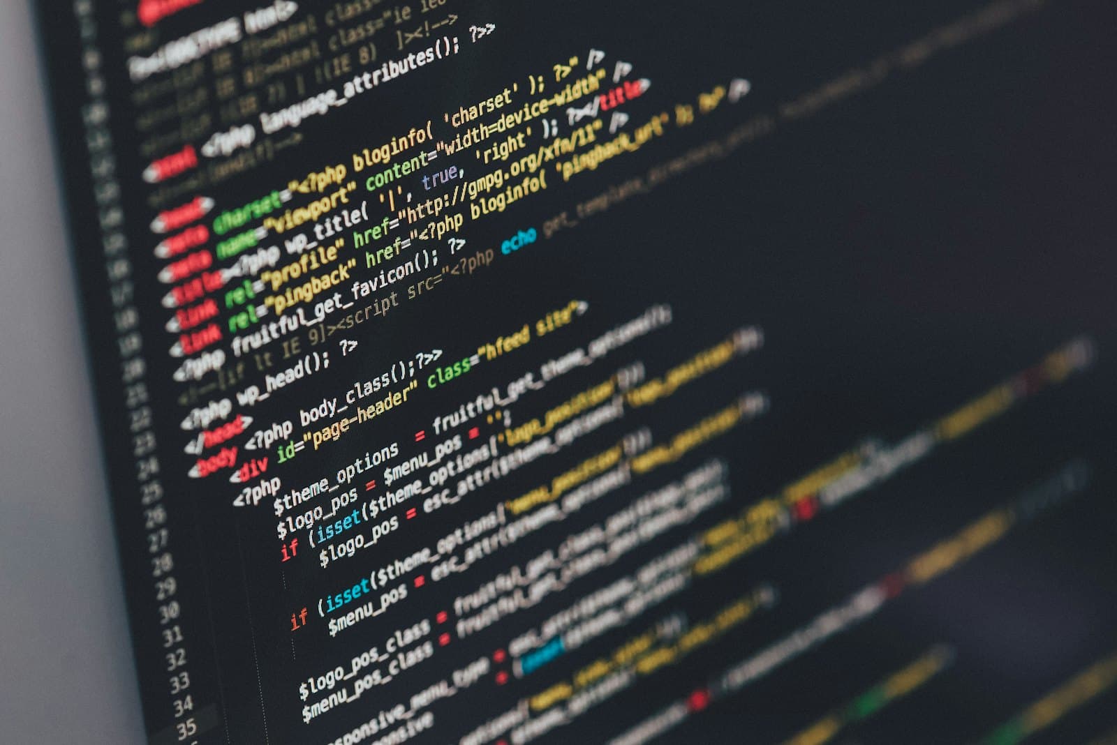 A designer and a developer reviewing a custom website layout on screen.